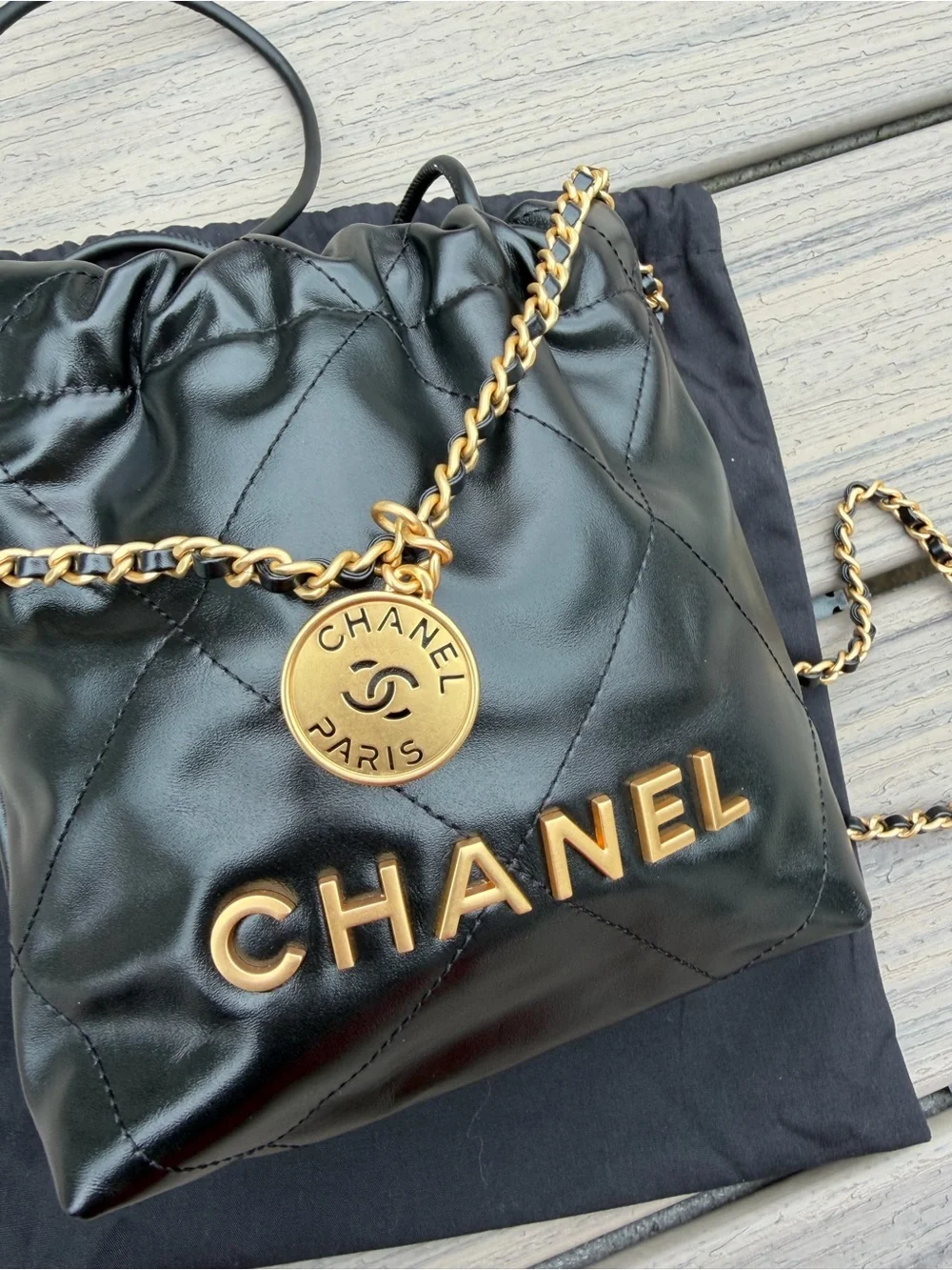 CHANEL Black Quilted Leather Drawstring Crossbody with Gold Chain